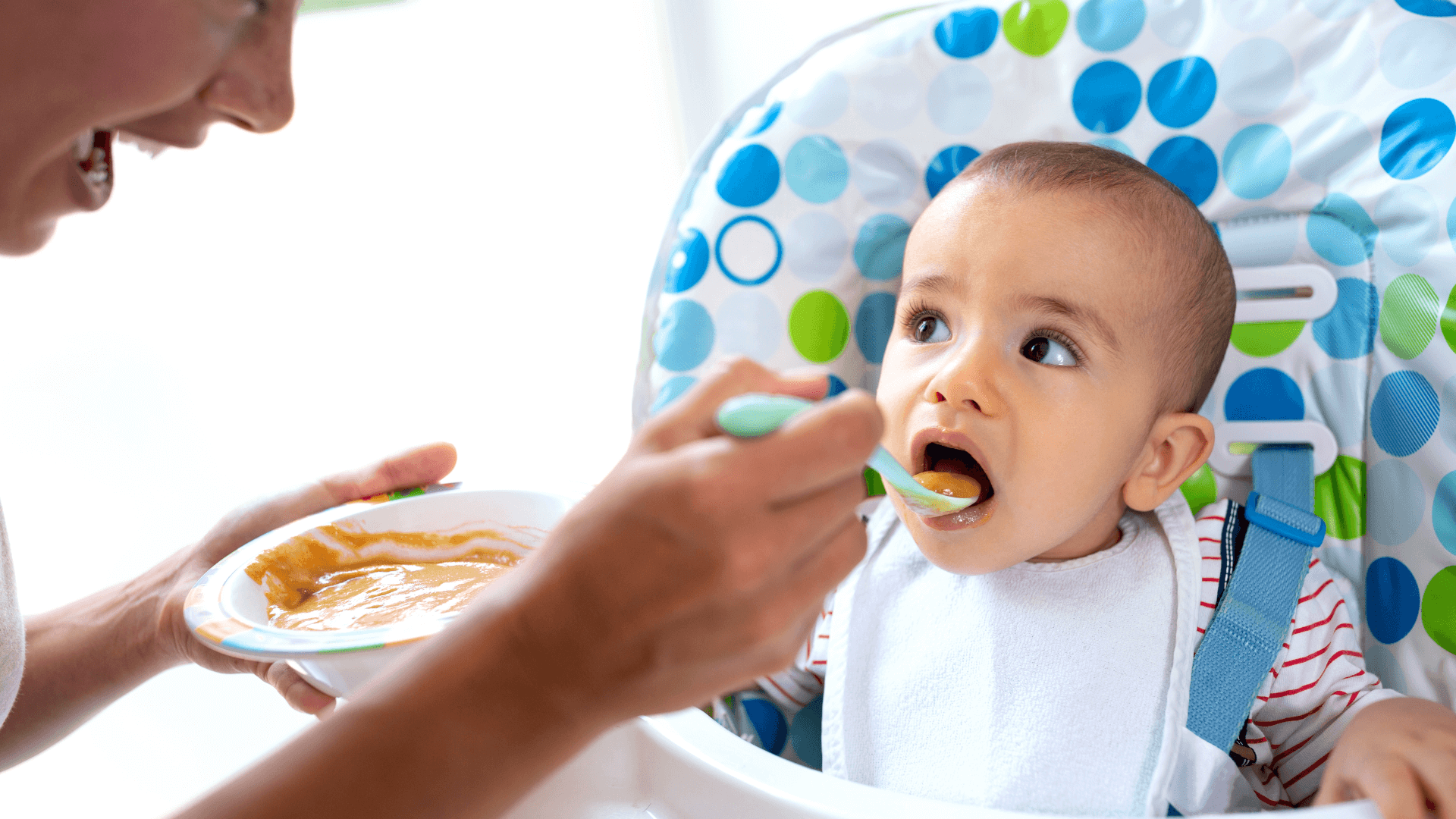 Mother introducing solids to baby